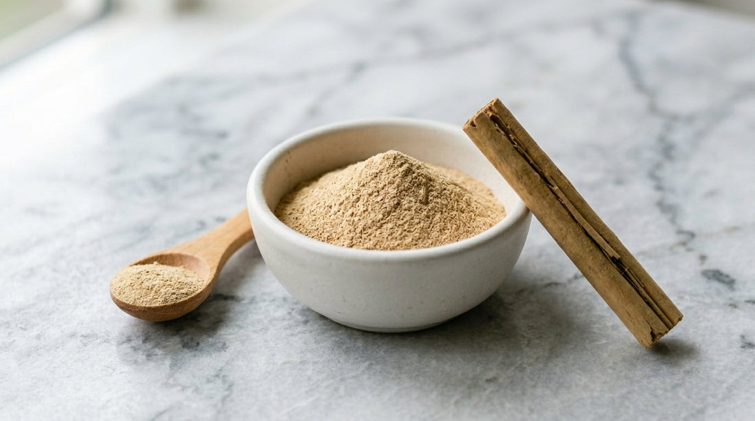 A small matte  white ceramic bowl containing a precise mound of fine Ceylon  cinnamon powder, light tan in color — not the reddish-brown  of cassia. 