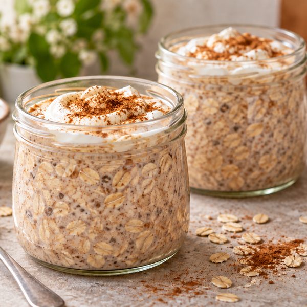 Cinnamon overnight oats with a white yogurt swirl in two jars